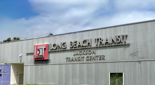 Warehouse or workshop with a sign that says Long Beach Transit, Jackson Transit Center on it